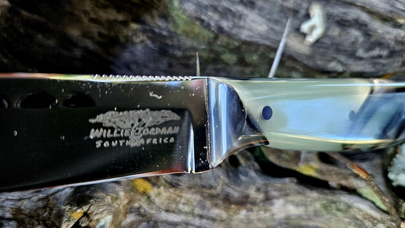 The Willie Jordaan South Africa maker's mark etched on a 1095 carbon blade